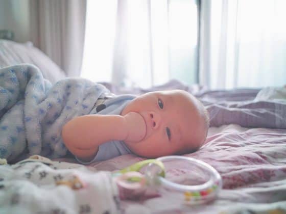 Baby lying down on the bed.